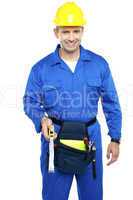 Repairman at work holding measuring tape