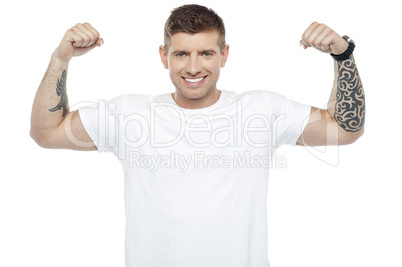 Muscular handsome young man showing his biceps