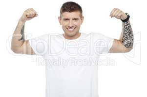 Muscular handsome young man showing his biceps