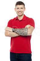 Stylish man with tattoo on hand posing with folded arms