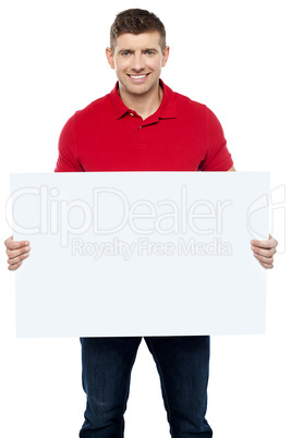 Casual guy presenting ad board