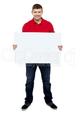 Handsome guy presenting blank billboard to camera