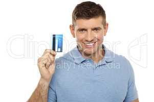 Cheerful man holding credit card