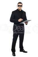 Male bouncer holding clipboard