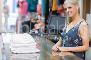 Smiling woman behind counter