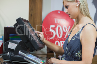 Woman is standing at the counter typing