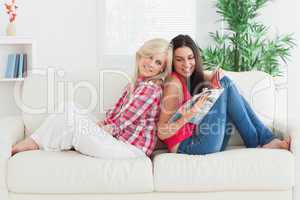Woman showing friend a magazine