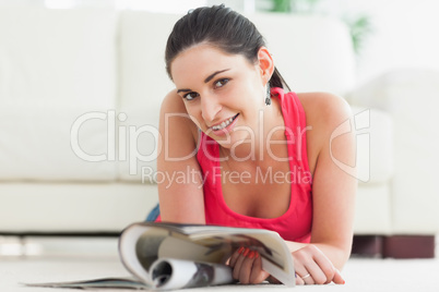 Woman is lying on the floor smiling