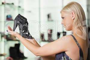 Woman looking at a shoe satisfied
