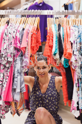 Woman standing behind a clothes rack