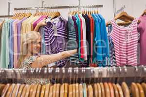 Woman looking at a clothes rack showing clothes