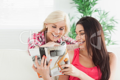 Women looking at the catalog smiling