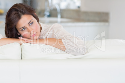 Thoughtful woman relaxing on the couch