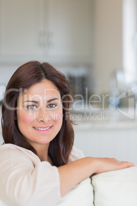 Smiling woman sitting on sofa