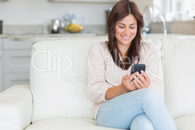 Brunette texting with mobile phone