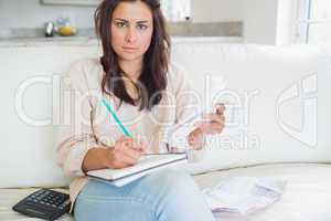 Young woman looking stressed over bills