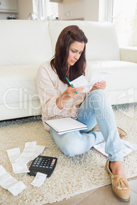 Woman checking bills in the living room