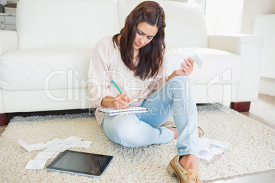Young woman adding receipts