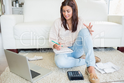 Woman working out finances with laptop