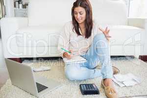 Woman working out finances with laptop