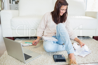 Woman using laptop to calculate bills