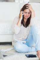 Woman on the phone getting stressed over bills