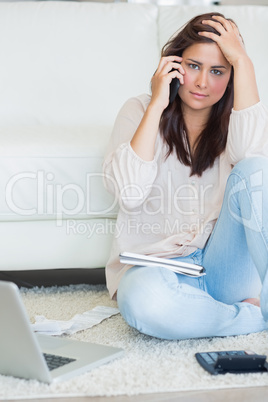 Woman sitting on the carpet and calling