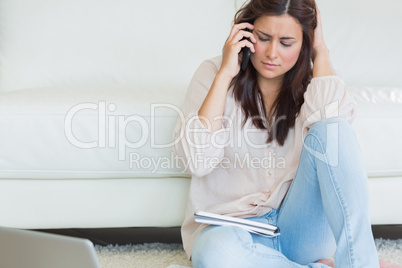 Women sitting on the carpet and calling