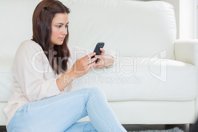 Brunette woman texting with her mobile phone Brunette woman texting with her mobile phone