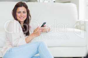 Brunette woman using her mobile phone