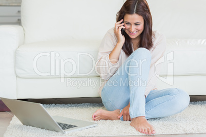 Woman calling in front of laptop