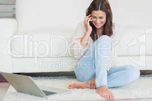 Woman calling in front of laptop