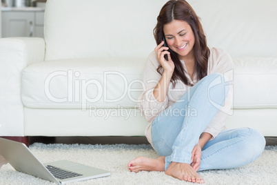Woman calling in front of a laptop
