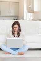 Brunette typing on laptop