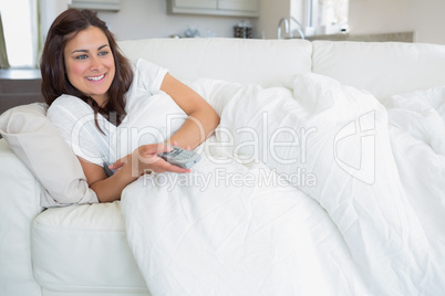 Smiling woman watching television