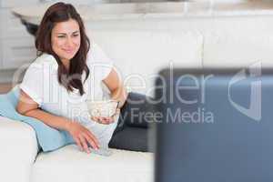 Woman enjoying tv with popcorn