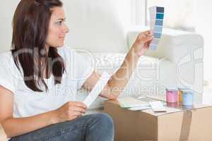 Woman choosing colour for painting