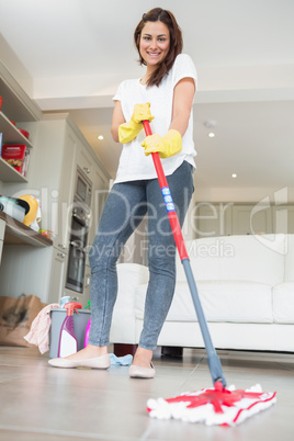 Brunette woman mopping the floor