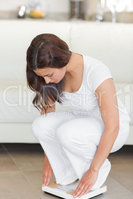 Woman weighing herself