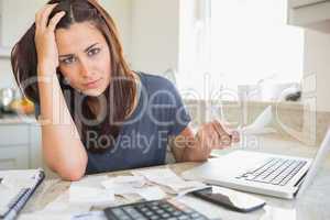 Young woman looking worried over finances