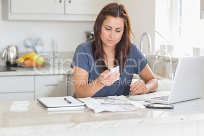 Brunette looking over bills