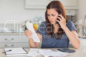 Woman calling while calculating