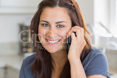 Brunette woman calling in the kitchen