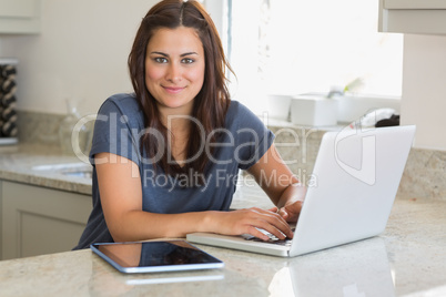 Woman using the laptop in the kitchen