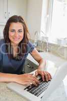 Woman using the laptop and smiling