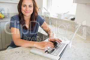 Brunette using a laptop