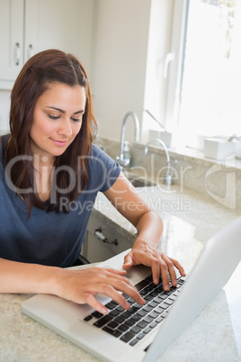 Brunette woman typing on the laptop