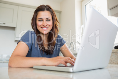 Woman smiling and using laptop