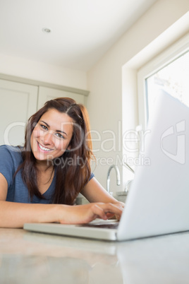 Cheerful woman using laptop