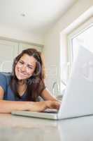 Cheerful woman using laptop